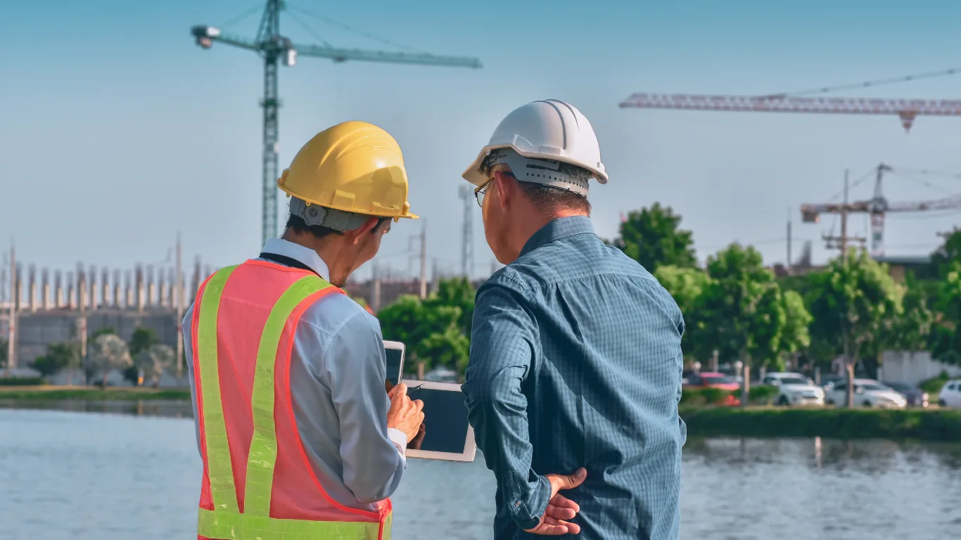 Due uomini guardano uno smartphone in cantiere